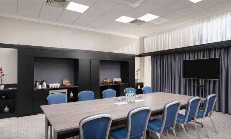 Elegant meeting room with TV for presentations at the Hilton London Gatwick Airport.