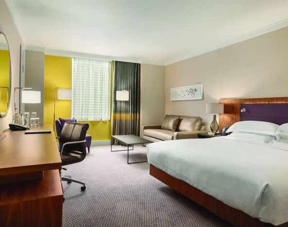 King guestroom with work desk at Hilton London Wembley.