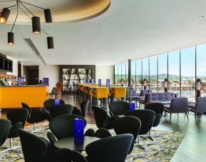 Rooftop bar with natural light at Hilton London Wembley.