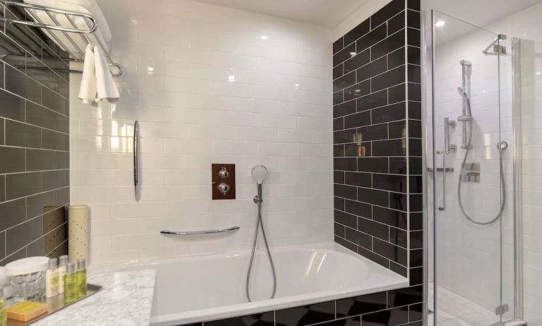 Guest bathroom with shower and tub at Hilton London Wembley.