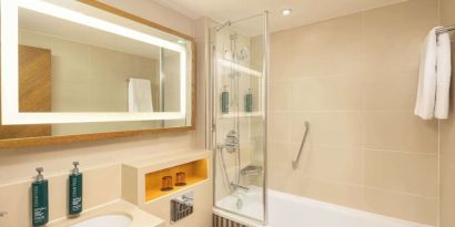 Guest bathroom with shower and tub at DoubleTree By Hilton London - Hyde Park.