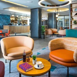 Lobby and coworking lounge at Hampton By Hilton London Park Royal.