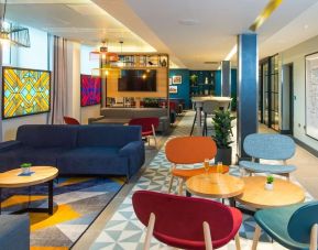 Lobby and coworking lounge at Hampton By Hilton London Park Royal.