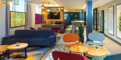 Lobby and coworking lounge at Hampton By Hilton London Park Royal.