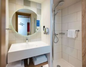 Guest bathroom with shower at Hampton By Hilton London Park Royal.