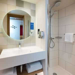 Guest bathroom with shower at Hampton By Hilton London Park Royal.