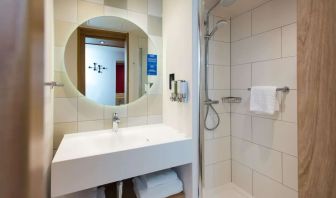 Guest bathroom with shower at Hampton By Hilton London Park Royal.