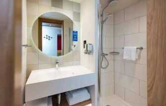 Guest bathroom with shower at Hampton By Hilton London Park Royal.