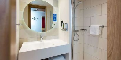 Guest bathroom with shower at Hampton By Hilton London Park Royal.