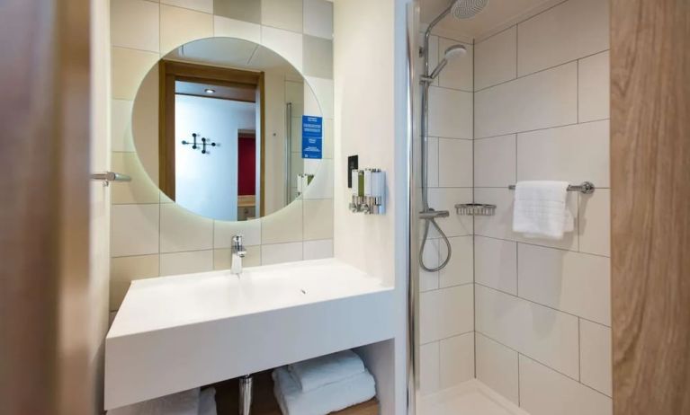 Guest bathroom with shower at Hampton By Hilton London Park Royal.