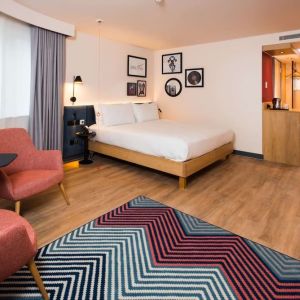 Comfortable king room with work desk and coffee station at Hampton By Hilton London Park Royal.