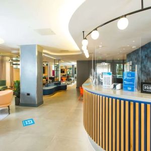 Lobby and coworking lounge at Hampton By Hilton London Park Royal.