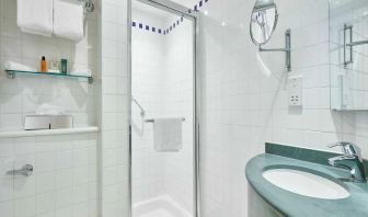 Guest bathroom with shower and toiletries at the Hilton Garden Inn Birmingham Brindleyplace.