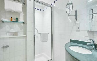 Guest bathroom with shower and toiletries at the Hilton Garden Inn Birmingham Brindleyplace.