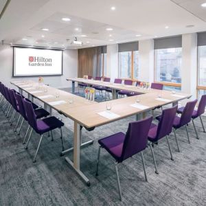 Spacious meeting room with comfortable mobiliary and large windows at the Hilton Garden Inn Birmingham Brindleyplace.