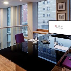 Meeting room with TV and large windows at the Hilton Garden Inn Birmingham Brindleyplace.