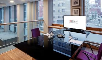 Meeting room with TV and big windows at the Hilton Garden Inn Birmingham Brindleyplace.