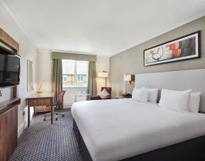 King bedroom with TV screen and desk at the DoubleTree by Hilton Bristol North.