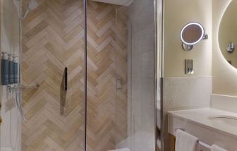 Guest bathroom with shower and toiletries at the DoubleTree by Hilton Bristol North.