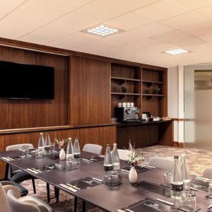 Professional meeting room with TV screen and coffee maker at the Hilton Birmingham Metropole.