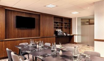 Professional meeting room with TV screen and coffee maker at the Hilton Birmingham Metropole.