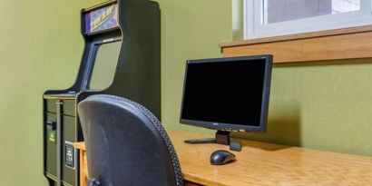 Work desk and ATM at Coratel Inn & Suites By Jasper River Falls.