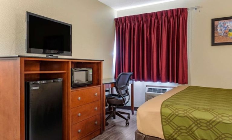 Day room with TV and fridge at Coratel Inn & Suites By Jasper River Falls.