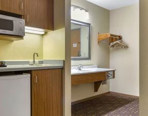 Guest bathroom and kitchen area at Coratel Inn & Suites By Jasper River Falls.