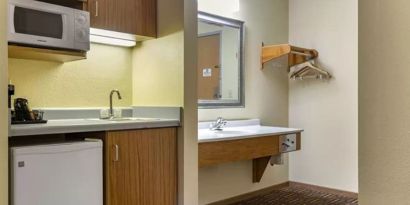 Guest bathroom and kitchen area at Coratel Inn & Suites By Jasper River Falls.