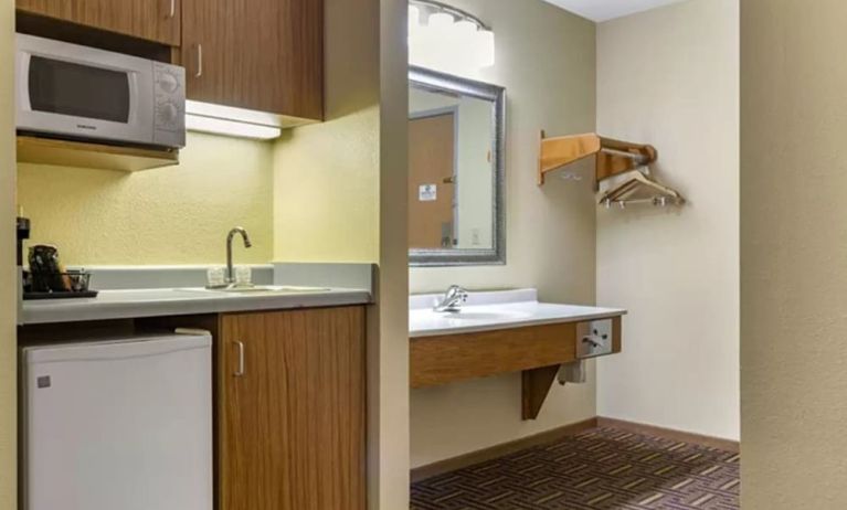 Guest bathroom and kitchen area at Coratel Inn & Suites By Jasper River Falls.