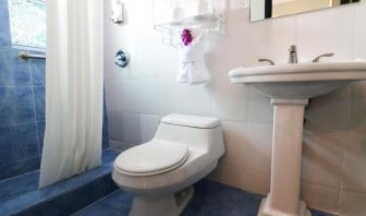 Guest bathroom with shower at Hollywood Beach Suites, A South Beach Group Hotel.