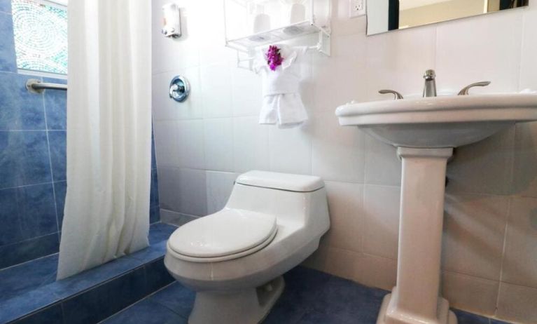 Guest bathroom with shower at Hollywood Beach Suites, A South Beach Group Hotel.