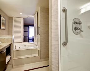 Guest bathroom with shower and tub at Fairfield By Marriott Guelph.