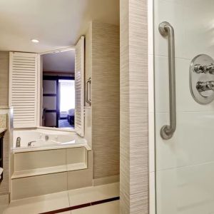 Guest bathroom with shower and tub at Fairfield By Marriott Guelph.