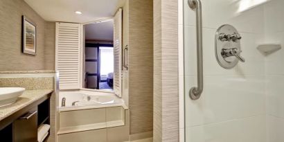 Guest bathroom with shower and tub at Fairfield By Marriott Guelph.