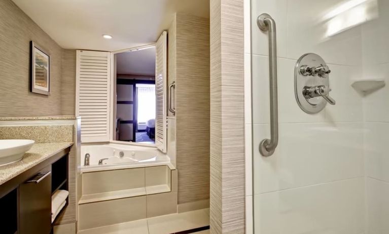 Guest bathroom with shower and tub at Fairfield By Marriott Guelph.