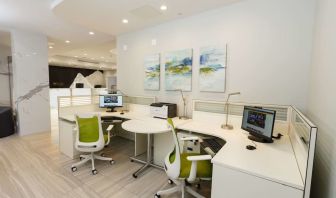 Business center with computers, ergonomic chairs and printer at Executive Residency By Best Western.