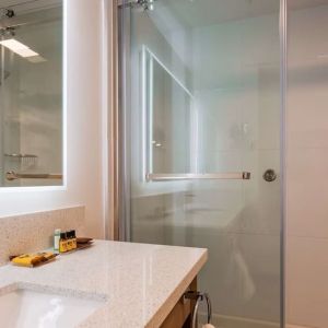 Day use guest bathroom with shower and toiletries at Executive Residency By Best Western.