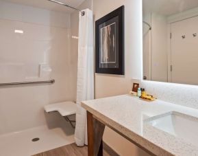 Day use guest bathroom with shower and toiletries at Executive Residency By Best Western.