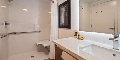 Day use guest bathroom with shower and toiletries at Executive Residency By Best Western.