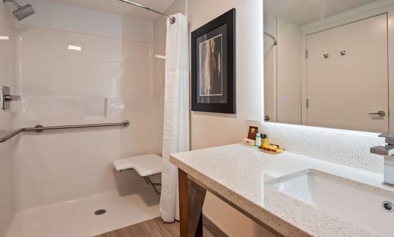 Day use guest bathroom with shower and toiletries at Executive Residency By Best Western.