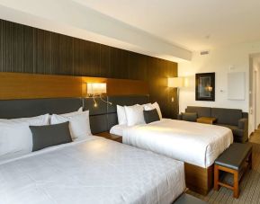 Twin bed day use room with sofa, work desk and private bathroom at Executive Residency By Best Western.