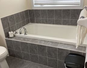 Guest bathroom with tub at Home Stay Canada.