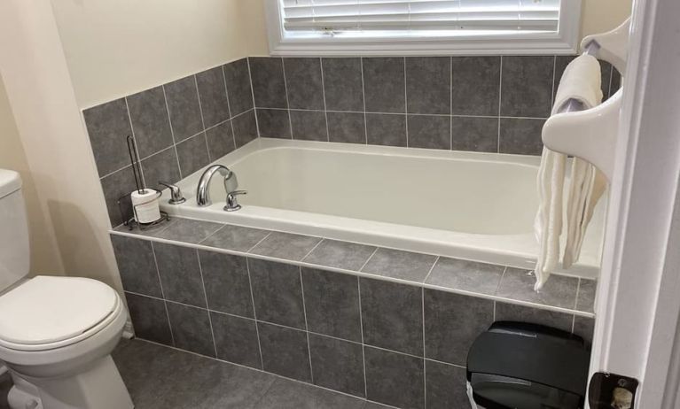 Guest bathroom with tub at Home Stay Canada.