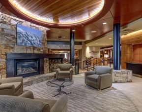 Hotel lobby with lounge area and fire place at Hilton Whistler Resort & Spa.