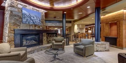 Hotel lobby with lounge area and fire place at Hilton Whistler Resort & Spa.