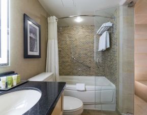 Guest bathroom with tub, sauna and toiletries at Hilton Whistler Resort & Spa.