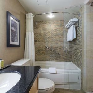 Guest bathroom with tub, sauna and toiletries at Hilton Whistler Resort & Spa.