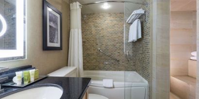 Guest bathroom with tub, sauna and toiletries at Hilton Whistler Resort & Spa.