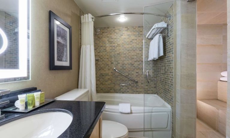 Guest bathroom with tub, sauna and toiletries at Hilton Whistler Resort & Spa.